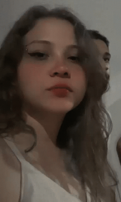 Blurry Man Holding Microphone In Front Of Crowd GIF