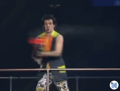Blurry Man Holding Water Gun With Letter N GIF