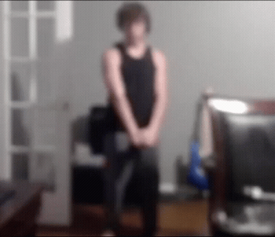 Blurry Man In Black Tank Top Standing GIF