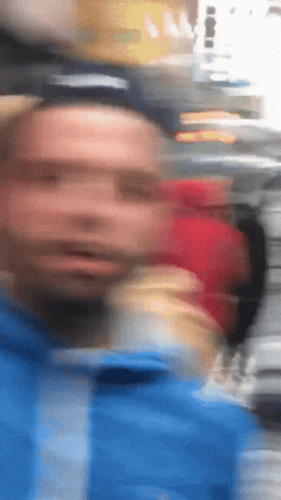 Blurry Man In Blue Jacket GIF