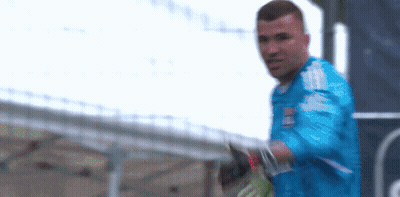 Blurry Man In Blue Shirt And Gloves GIF