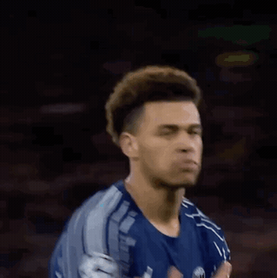 Blurry Man In Blue Shirt Holding Head GIF