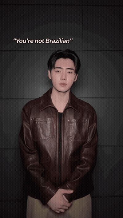 Blurry Man In Brown Jacket With OK GIF
