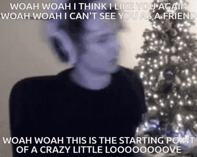 Blurry Man In Front Of Christmas Tree Saying Woah Woah I Think I Like You Again GIF
