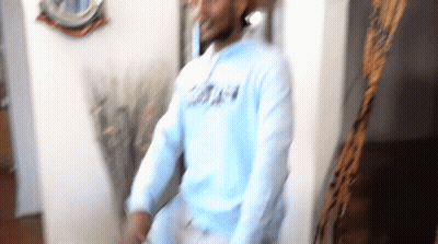 Blurry Man In Light Blue Sweatshirt Saying A GIF