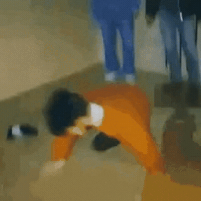 Blurry Man In Orange Jacket And Black Hat Dancing GIF