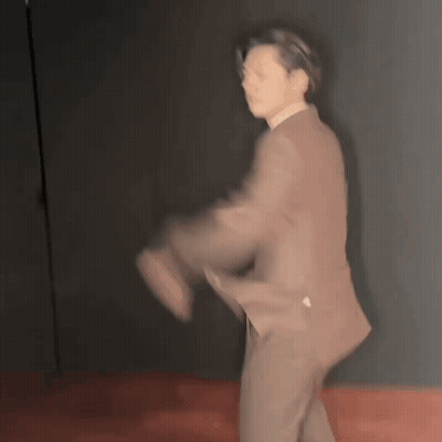 Blurry Man In Suit Dancing On Red Floor GIF