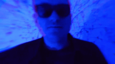 Blurry Man In Sunglasses With Blue Light GIF