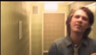 Blurry Man Looking In Mirror GIF