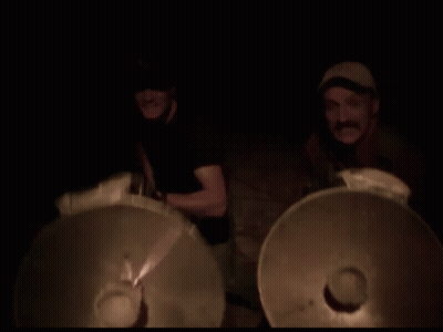 Blurry Man Playing Drums In Dark Room GIF