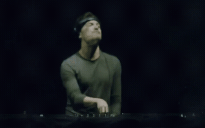 Blurry Man Playing Keyboard In Dark Room GIF