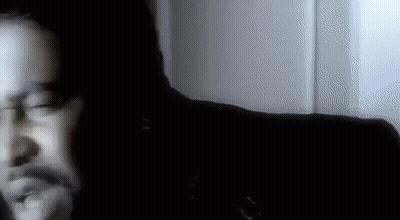 Blurry Man's Face In Dark Room GIF