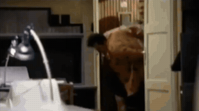 Blurry Man Standing In Doorway With Lamp GIF