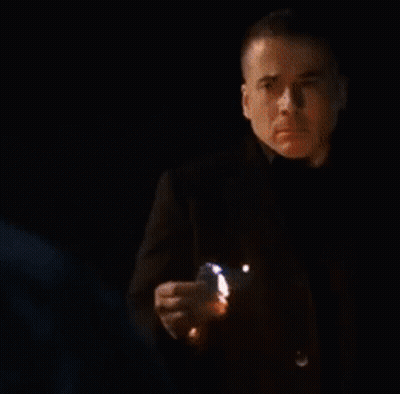Blurry Man Standing In Front Of Flames GIF