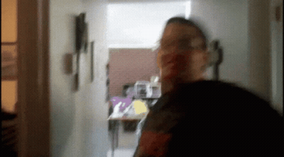 Blurry Man Standing In Hallway GIF