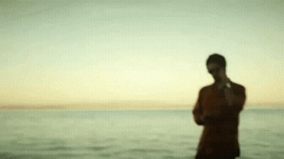 Blurry Man Standing On Beach GIF