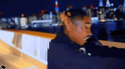 Blurry Man Standing On Bridge At Night GIF