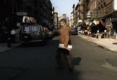 Blurry Man Walking Down Street With Van GIF