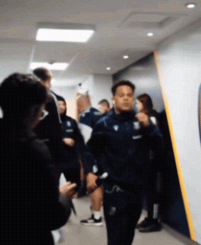 Blurry Man Walking In Hallway With Yellow Stripe GIF