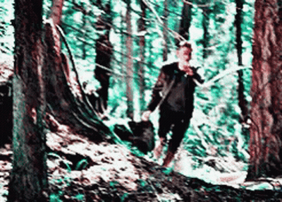 Blurry Man Walking Through Forest GIF