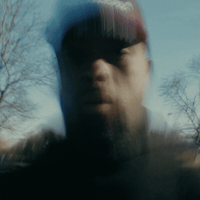 Blurry Man With Beard in Red Coca Cola Hat