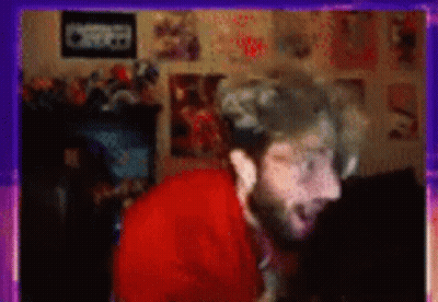 Blurry Man With Beard In Room With Posters GIF