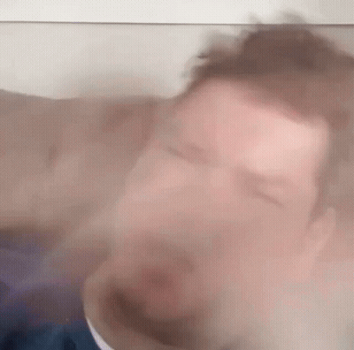 Blurry Man With Eyes Closed Behind Glass GIF