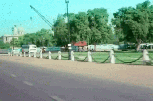 Blurry Park With Fence And Building GIF