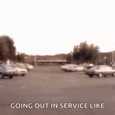Blurry Parking Lot Sign Saying Going Out In Service Like GIF