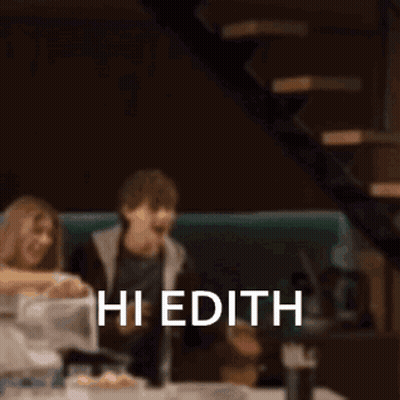 Blurry People at Table Saying Hi Edith