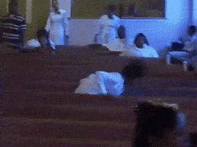 Blurry People Sitting In Church GIF