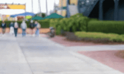 Blurry People Walking On Sidewalk GIF