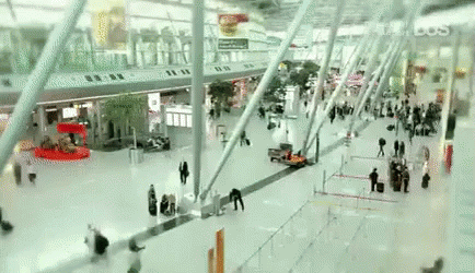 Blurry People Walking Through Airport Terminal