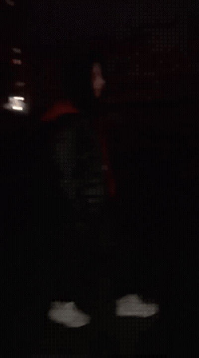 Blurry Person Behind Fence At Night GIF