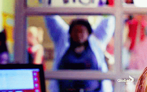 Blurry Person Behind Window With Globe Logo GIF