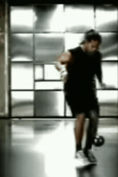 Blurry Person Holding Basketball In Gym GIF