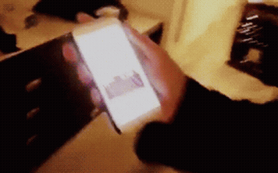 Blurry Person Holding Cell Phone GIF