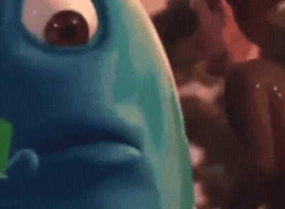 Blurry Person Holding Green Cube GIF