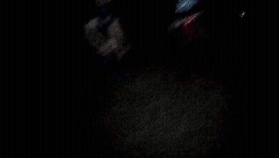 Blurry Person Holding Head In Dark Room GIF