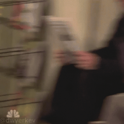 Blurry Person Holding Newspaper GIF