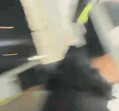 Blurry Person Holding Yellow Object GIF