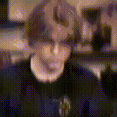 Blurry Person In Black Shirt And Necklace GIF