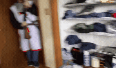 Blurry Person In Closet With Clothes GIF