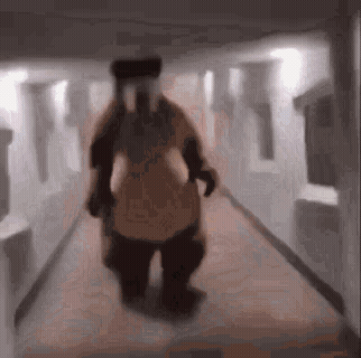Blurry Person In Costume Walking Down Hallway GIF