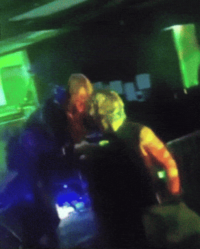 Blurry Person In Dark Room With Rainbow Colors GIF