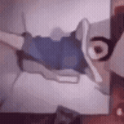 Blurry Person Laying on Bed With Cartoon Character