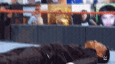 Blurry Person Laying On Ground With Wrestling Logo GIF