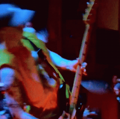 Blurry Person Playing Guitar In Dark Room GIF
