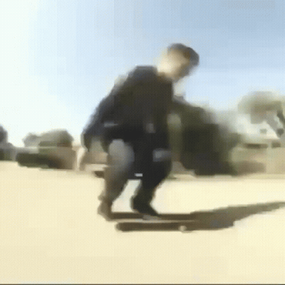Blurry Person Riding Skateboard Down Street