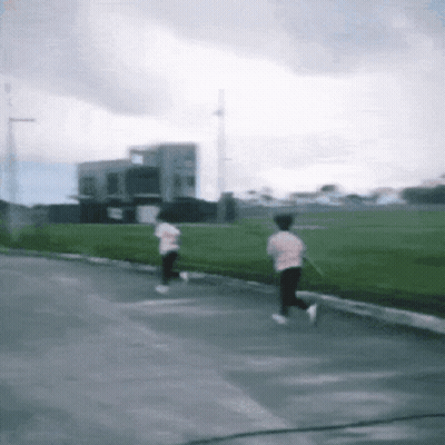 Blurry Person Running Down Street GIF